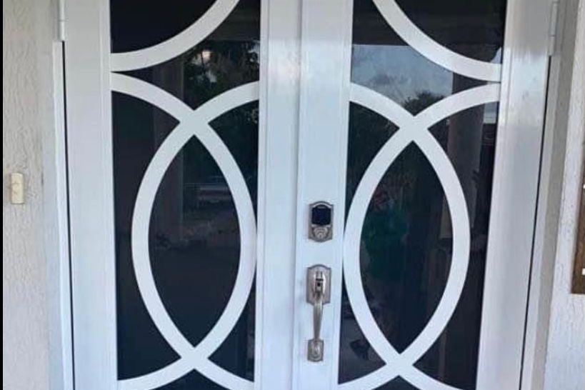 Wood-look entry door with glass panels and side lights on a Florida home