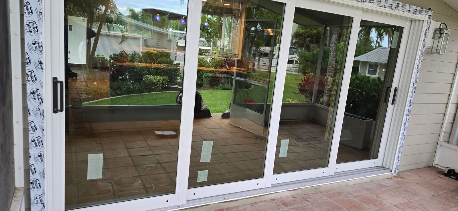 Wide sliding glass door opening to a patio and pool area